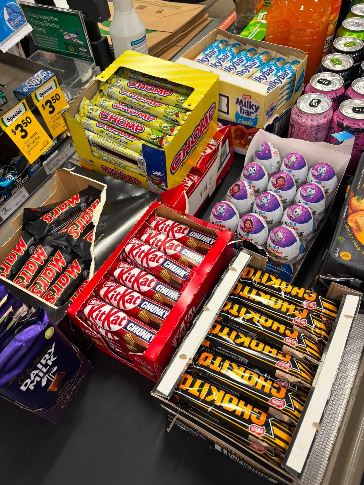 Chocolate bars, Kit Kat, Kinder and Chomp displayed at the counter of Giru Convenience
