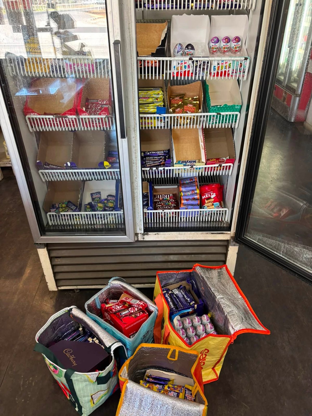 Drinks fridge and ice cream freezer stocked with treats at Giru Convenience